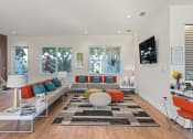 Thumbnail 28 of 51 - a living room with couches and chairs and a television at Lake Lofts at Deerwood, Jacksonville, 32216