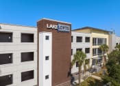 Thumbnail 17 of 51 - a view of the front of a building with a sign for lake acres apartments at Lake Lofts at Deerwood, Florida, 32216