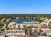 Thumbnail 8 of 51 - an aerial view of a building next to a lake at Lake Lofts at Deerwood, Jacksonville