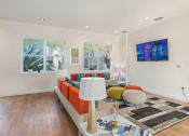 Thumbnail 37 of 51 - a living room with a couch and a table at Lake Lofts at Deerwood, Jacksonville, FL, 32216