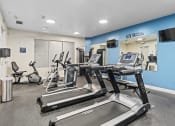 Thumbnail 39 of 51 - a gym with treadmills and other exercise equipment in a building at Lake Lofts at Deerwood, Jacksonville, FL