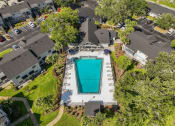 Thumbnail 19 of 21 - a birds eye view of a swimming pool in a neighborhood with houses and trees at Oak Reserve at Winter Park, Winter Park