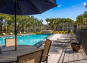 Thumbnail 18 of 21 - our apartments have a resort style pool with tables and chairs at Oak Reserve at Winter Park, Winter Park, Florida