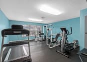 Thumbnail 14 of 21 - the gym has cardio machines and weights in it at the enclave at woodbridge apartments at Oak Reserve at Winter Park, Florida