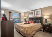 Thumbnail 8 of 21 - our apartments offer a spacious bedroom with a king sized bed at Oak Reserve at Winter Park, Winter Park, FL, 32792