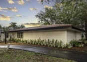 Thumbnail 19 of 54 - a house with a driveway and trees in the background  at Club at Emerald Waters, Hollywood, 33021