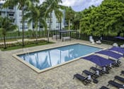 Thumbnail 22 of 54 - a resort style swimming pool with lounge chairs and umbrellas  at Club at Emerald Waters, Hollywood, FL, 33021