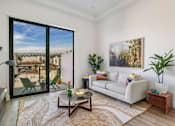 Thumbnail 7 of 27 - A living room with a large window overlooking a cityscape at WM by CLG, California, 90232