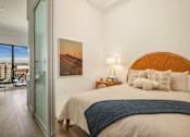 Thumbnail 10 of 27 - A bedroom with a large bed and a painting of a road with power lines on the wall at WM by CLG, California  
