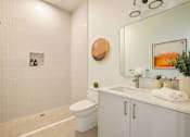 Thumbnail 23 of 27 - A bathroom with a white toilet and a white sink at WM by CLG, Los Angeles, CA 90232  