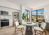 Thumbnail 3 of 27 - A modern kitchen with a dining table and chairs at WM by CLG, Los Angeles California  