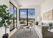 Thumbnail 6 of 27 - A living room with a large window overlooking a landscape at WM by CLG, Los Angeles  