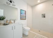 Thumbnail 17 of 27 - A bathroom with a white toilet and a white sink at WM by CLG, Los Angeles, 90232  