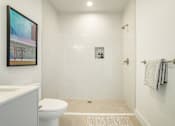 Thumbnail 16 of 27 - A white bathroom with a toilet, sink, and shower at WM by CLG, California, 90232