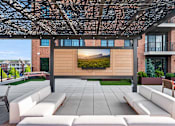 Thumbnail 29 of 39 - A modern outdoor seating area with a large screen displaying a landscape.