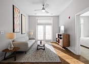 Thumbnail 4 of 34 - A living room with double doors to a patio providing natural light, hardwood-style flooring, a ceiling fan, and access to a bedroom.