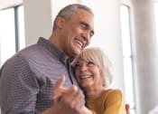 Thumbnail 5 of 17 - a man and a woman holding each other and smiling while dancing