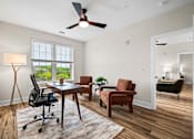 Thumbnail 6 of 39 - A room with a ceiling fan and a table with chairs.
