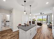 Thumbnail 13 of 39 - A kitchen with a large island and a dining area.