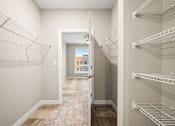 Thumbnail 9 of 34 - A hallway with a doorway leading to a balcony.