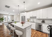 Thumbnail 34 of 34 - A modern kitchen with white cabinets and a center island.