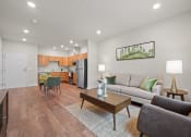Thumbnail 7 of 17 - a living room with a couch and a table