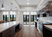 Thumbnail 13 of 17 - a large kitchen with an island and stainless steel appliances