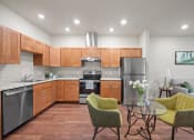 Thumbnail 4 of 17 - a kitchen with wooden cabinets and a table with chairs