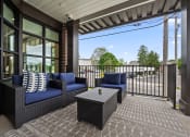 Thumbnail 16 of 17 - a patio with couches and a coffee table on a balcony