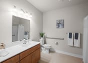 Thumbnail 8 of 17 - a bathroom with a large mirror and a sink and a toilet