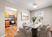 Thumbnail 2 of 64 - A dining room with a table and chairs.