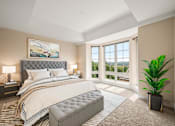 Thumbnail 4 of 59 - A bedroom with a large bed and a painting on the wall.