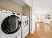 Thumbnail 47 of 59 - A laundry room with a washer and dryer.