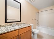 Thumbnail 46 of 59 - A bathroom with a sink, toilet, and bathtub.