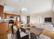 Thumbnail 6 of 59 - A modern kitchen with a dining table and chairs.