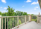 Thumbnail 11 of 59 - A balcony with a railing overlooking a green landscape.