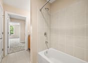 Thumbnail 9 of 59 - A bathroom with a white tub and a walk in shower.