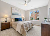 Thumbnail 5 of 39 - Spacious luxury bedroom with soft natural light and a modern ceiling fan, designed for comfortable living at Claremont on the Square in Exton.
