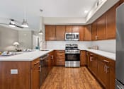 Thumbnail 3 of 30 - A modern kitchen with wooden cabinets and stainless steel appliances.