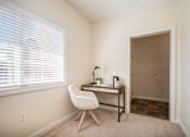 Thumbnail 7 of 45 - A room with a desk and chair by the window.