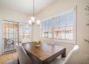 Thumbnail 14 of 45 - Dining room with table and chairs overlooking patio.