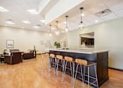Thumbnail 32 of 45 - A modern kitchen with a bar area and seating.