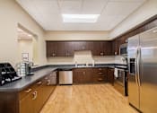 Thumbnail 33 of 45 - Kitchen with cherry oak cabinets and light wooden floors.