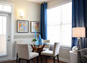 Thumbnail 16 of 26 - Dining nook with natural light and blue curtains at GrandView Flats and Townhomes Apartments, Granger, IN