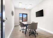 Thumbnail 12 of 28 - a conference room with a table and chairs and a television at The Junction at Rogers, Rogers, 72756
