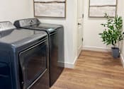 Thumbnail 22 of 28 - A black oven sits next to a black dishwasher in a kitchen.