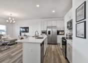 Thumbnail 5 of 33 - an open kitchen and living room with a refrigerator and a sink at The Prairie Villas, Dardenne Prairie, MO 63368