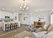 Thumbnail 8 of 33 - a living room and kitchen with a couch and a table at The Prairie Villas, Dardenne Prairie, MO