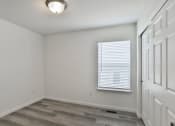 Thumbnail 12 of 33 - an empty room with a window and a white door at The Prairie Villas, Dardenne Prairie, 63368