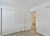 Thumbnail 15 of 33 - a bedroom with two closets and a door to a bathroom at The Prairie Villas, Dardenne Prairie, MO